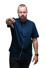 Poster - Young caucasian hipster man over isolated background looking unhappy and angry showing rejection and negative with thumbs down gesture. Bad expression.