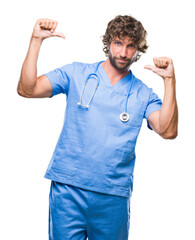 Wall Mural - Handsome hispanic surgeon doctor man over isolated background looking confident with smile on face, pointing oneself with fingers proud and happy.