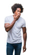© Krakenimages.com - Afro american man over isolated background bored yawning tired covering mouth with hand. Restless and sleepiness.