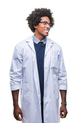 Sticker - Afro american doctor scientist man over isolated background looking away to side with smile on face, natural expression. Laughing confident.