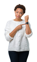 Sticker - Beautiful young african american woman wearing sweater over isolated background In hurry pointing to watch time, impatience, upset and angry for deadline delay