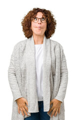 Sticker - Beautiful middle ager senior woman wearing jacket and glasses over isolated background making fish face with lips, crazy and comical gesture. Funny expression.