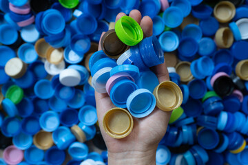 woman hand holding plastic bottles caps for recycling to conserve the environment, Recycling, reuse, garbage disposal, save the world concpet.