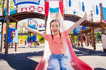 Canvas Print - Portrait of adorable funny little girl have fun outside slide playground hill activity enjoy summer weekend pastime fresh air outdoor