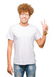 © Krakenimages.com - Young handsome man with afro hair wearing glasses smiling with happy face winking at the camera doing victory sign. Number two.