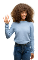 Poster - African american woman wearing a sweater showing and pointing up with fingers number five while smiling confident and happy.