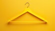 © Emin - Yellow background with copy space for clothes hanger Household item for storing goods