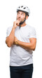 © Krakenimages.com - Young handsome man wearing cyclist safety helmet over isolated background with hand on chin thinking about question, pensive expression. Smiling with thoughtful face. Doubt concept.