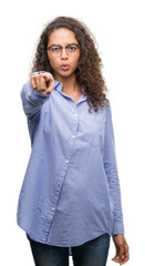 Poster - Beautiful young hispanic woman wearing glasses pointing with finger to the camera and to you, hand sign, positive and confident gesture from the front