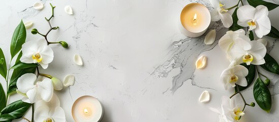 Leinwandbilder - Create a soothing spa ambiance for a massage with candles orchids and a white backdrop in this top down view frame with copy space image