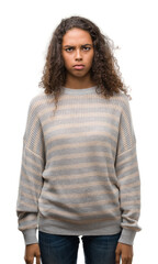 Canvas Print - Beautiful young hispanic woman wearing stripes sweater skeptic and nervous, frowning upset because of problem. Negative person.