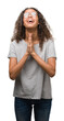 © Krakenimages.com - Beautiful young hispanic woman wearing glasses begging and praying with hands together with hope expression on face very emotional and worried. Asking for forgiveness. Religion concept.