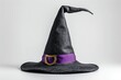 © Dassen - Black witch hat with purple ribbon on white background. Halloween concept.