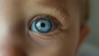© RaptorWoman - Extreme close-up shot of a baby's bright blue eye, showcasing intricate details of the eye and eyelashes.