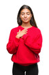 © Krakenimages.com - Young beautiful arab woman wearing winter sweater over isolated background smiling with hands on chest with closed eyes and grateful gesture on face. Health concept.