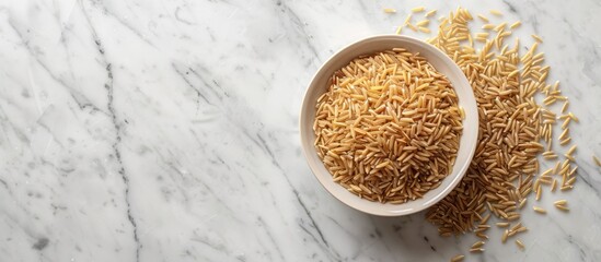 Aufkleber - An arrangement of appetizing brown rice placed on a white marble surface with ample space for including text in the copy space image