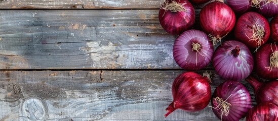 Aufkleber - Red Onions on a bright wooden surface creating a backdrop for text with a focused view from above suitable for a copy space image