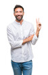 © Krakenimages.com - Adult hispanic man over isolated background smiling with happy face winking at the camera doing victory sign. Number two.