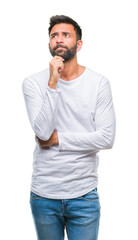 Sticker - Adult hispanic man over isolated background with hand on chin thinking about question, pensive expression. Smiling with thoughtful face. Doubt concept.