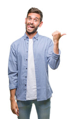 Poster - Young handsome man wearing white t-shirt over isolated background smiling with happy face looking and pointing to the side with thumb up.