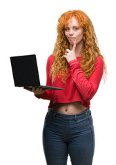 Sticker - Young redhead woman using computer laptop serious face thinking about question, very confused idea