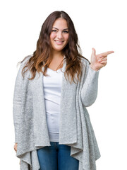 Wall Mural - Beautiful plus size young woman wearing winter jacket over isolated background with a big smile on face, pointing with hand and finger to the side looking at the camera.