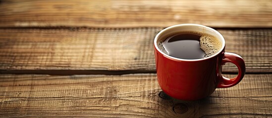 Wall Mural - Coffee cup resting on a wooden surface with copy space image