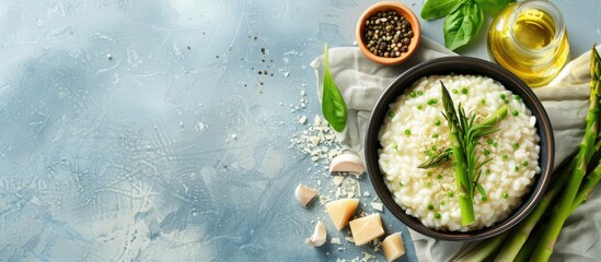 Poster - Top view of Italian risotto with fresh spring asparagus and flavorful Parmesan cheese on a bright background featuring ample copy space image