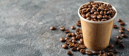 Aufkleber - A paper cup filled with coffee beans against a grey backdrop with ample copy space image