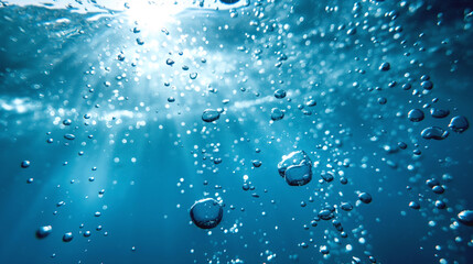 Poster - Underwater view with bubbles rising to the surface and sunlight filtering through the water, highlighting the clarity and motion of the scene.