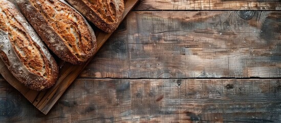 Aufkleber - Browned bread on a rustic wooden backdrop with copy space image