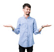 © Krakenimages.com - Young handsome business man over isolated background Smiling showing both hands open palms, presenting and advertising comparison and balance