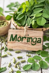 Wall Mural - Moringa leaves and supplements capsules. Selective focus.