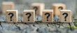 © vxnaghiyev - Four wooden blocks with black question marks placed in an arrangement with copy space image