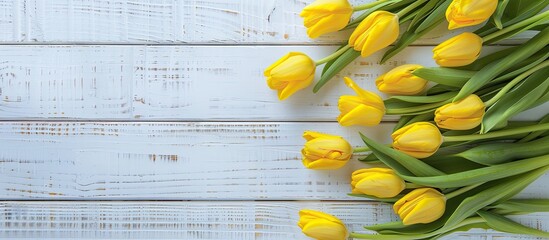 Aufkleber - Top view of yellow tulips on a white wooden surface providing ample copy space for text or image highlighted in the composition