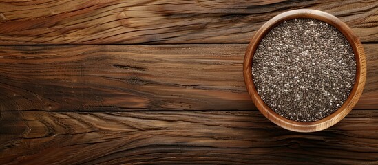 Leinwandbilder - Chia seeds in a bowl displayed on a wooden surface with a blank area for additional content copy space image