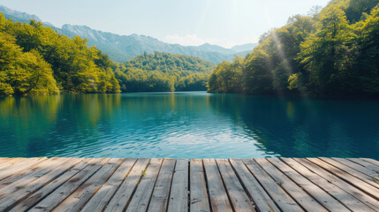 Poster - Serene lake surrounded by lush trees and mountains, viewed from a wooden pier, with a bright sun shining over the natural landscape.