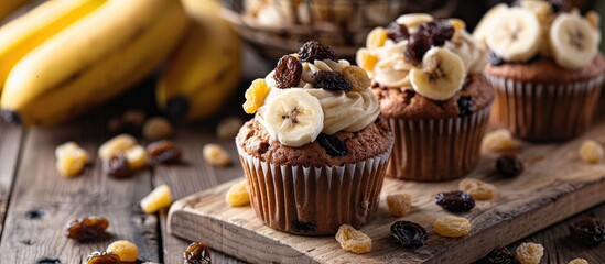 Fototapete - Banana cupcake with raisins on a wooden table for a copy space image