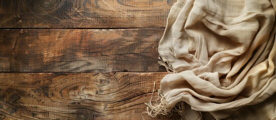 Sticker - An overhead shot of an old wooden table covered with a linen kitchen towel or napkin on a kitchen countertop with a rustic tablecloth perfect for a copy space image