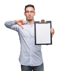 Sticker - Handsome young business man showing a clipboard with angry face, negative sign showing dislike with thumbs down, rejection concept