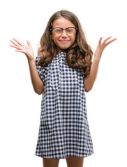 Sticker - Brunette hispanic girl wearing glasses very happy and excited, winner expression celebrating victory screaming with big smile and raised hands