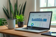 © forenna - sleek office setup with a laptop showing analytics, a coffee cup, and a green potted plant on a wooden desk, with a soft focus background. Perfect for illustrating modern work envi