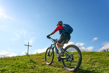 Wall Mural - nice active senior woman riding her electric mountain bike at Mount Huendle in Oberstaufen, Allgaeu Alps , Bavaria, Germany