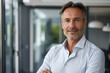 © john - mature 50 year old confident professional manager, confident businessman investor looking at camera, smiling mid aged older business man executive standing in office, portrait