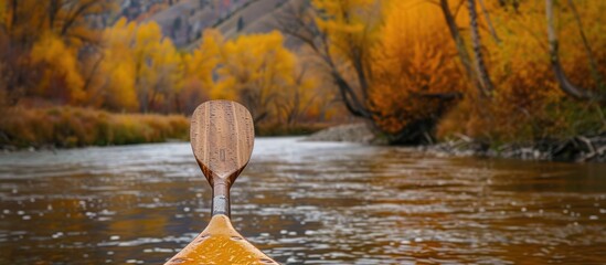 Sticker - fall foliage by snake river in jackson hole wy showcasing a canoe paddle in the foreground ideal for