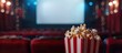 © Ilgun - Concept of a cinema setting with popcorn a blank screen in the background for copy space image