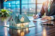 © Caitlin - A concept holo 3d render model of a small living house on a table in a real estate agency. signing mortgage contract document and demonstrating. futuristic business. blurry background