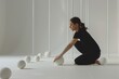 © Dina - mental focus of a woman person concentrating on yoga meditation balance exercise, with a serene expression and focused gaze, backdrop of minimalist studio settings and clean lines