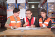 © DG PhotoStock - Team of warehouse staffs have a morning brief together before going to work.