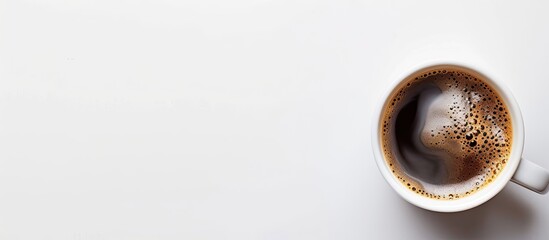 Canvas Print - Top view of a steaming cup of fragrant coffee set against a white backdrop with copy space image